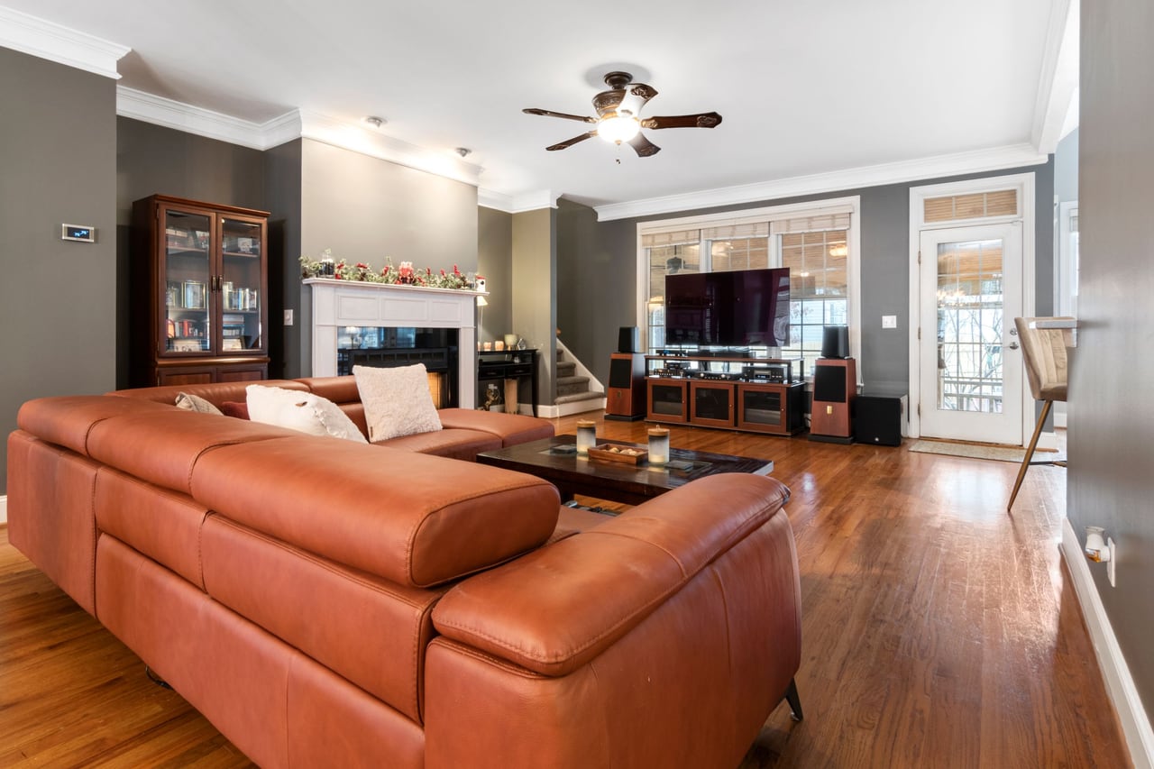 Tan leather sofa in a sunlit room with soft wall shadows